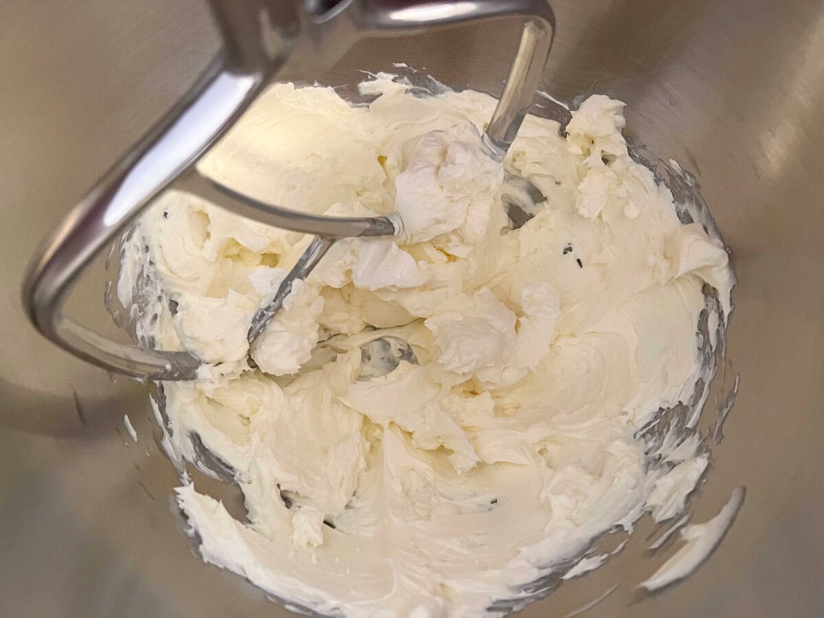 Butter, cream cheese, and sugar mixture in mixing bowl.