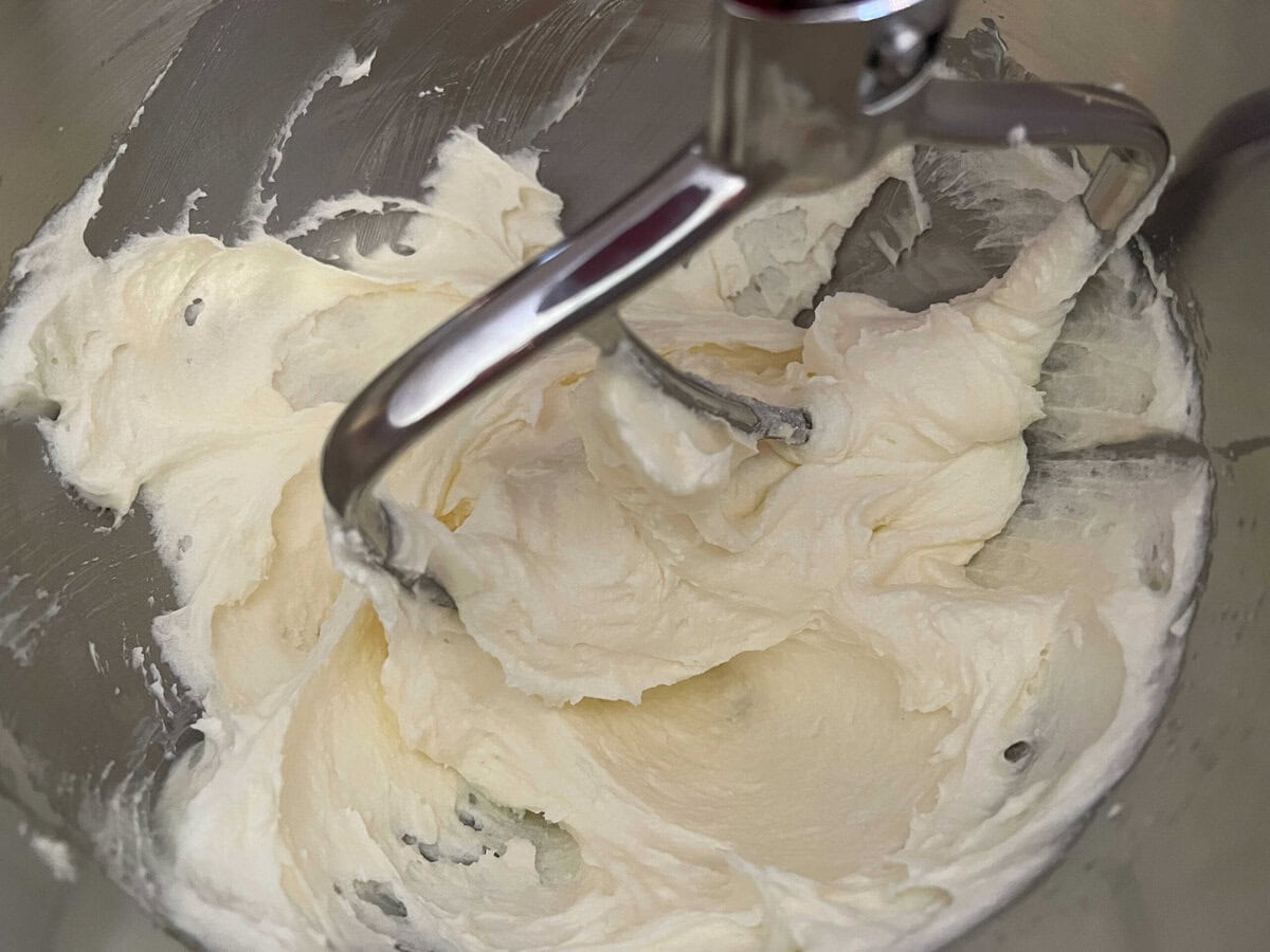 Mixing butter, cream cheese, and sugar.